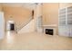 Open living area with a fireplace, built-in shelves, tile floors, and a staircase at 728 W Sandra Ter, Phoenix, AZ 85023