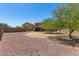 Desert landscaped backyard with covered patio, offering a private outdoor space at 7725 S 47Th Ln, Laveen, AZ 85339