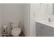 This small bathroom has white walls, grey cabinets, and an updated toilet at 7725 S 47Th Ln, Laveen, AZ 85339