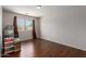 Bedroom with hardwood floors, a large window, and neutral walls at 7725 S 47Th Ln, Laveen, AZ 85339