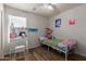 Comfortable bedroom with a ceiling fan and a corner window at 7725 S 47Th Ln, Laveen, AZ 85339