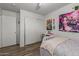 Comfortable bedroom with wood floors, closet, and decorated walls; bright and inviting at 7725 S 47Th Ln, Laveen, AZ 85339