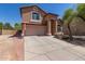 Charming home with a well-maintained front yard, two-car garage, and desert landscaping at 7725 S 47Th Ln, Laveen, AZ 85339