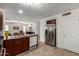 A modern kitchen with stainless steel appliances, a double sink, and dark wood cabinets at 7725 S 47Th Ln, Laveen, AZ 85339