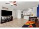 Spacious living room flowing into the kitchen, featuring tile floors, and ample natural light at 7725 S 47Th Ln, Laveen, AZ 85339