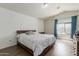 Main bedroom with laminate floors, vaulted ceilings, and natural light at 7725 S 47Th Ln, Laveen, AZ 85339