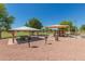 Community park featuring a shaded picnic area and colorful playground equipment at 7725 S 47Th Ln, Laveen, AZ 85339