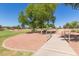 Community park featuring lush green spaces, walking paths, and mature trees at 7725 S 47Th Ln, Laveen, AZ 85339