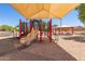 Community playground featuring colorful play structures with shaded canopy at 7725 S 47Th Ln, Laveen, AZ 85339