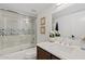 Bright bathroom featuring a tub with decorative tiled backsplash and a modern vanity at 7920 E Camelback Rd # 508, Scottsdale, AZ 85251