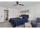 Bedroom with a ceiling fan and stylish decor, plus a seating area with blue patterned chair at 7920 E Camelback Rd # 508, Scottsdale, AZ 85251