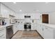 Updated kitchen with white cabinets, stainless appliances, and wood-look floors is move-in ready at 7920 E Camelback Rd # 508, Scottsdale, AZ 85251