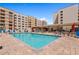A refreshing community pool with lounge seating, umbrellas and nearby buildings at 7920 E Camelback Rd # 508, Scottsdale, AZ 85251
