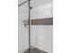 Walk-in shower boasts sleek, white tile and a decorative horizontal stripe at 7920 E Camelback Rd # 508, Scottsdale, AZ 85251