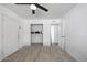 Bright bedroom with ceiling fan, tile flooring, and open closet at 8202 W Turney Ave, Phoenix, AZ 85033