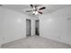 Light and airy bedroom with ceiling fan, white walls, tile flooring, and closet at 8202 W Turney Ave, Phoenix, AZ 85033