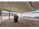 Spacious covered patio with concrete flooring, featuring a grill and ample space for outdoor seating at 8202 W Turney Ave, Phoenix, AZ 85033