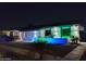 Charming home exterior with a delightful fountain and vibrant lighting creating an inviting ambiance in the evening at 8202 W Turney Ave, Phoenix, AZ 85033