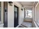 Inviting front porch with a stylish black door and charming outdoor lighting fixtures at 8202 W Turney Ave, Phoenix, AZ 85033