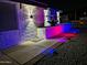 Night shot of a meticulously-kept front yard illuminated by exterior lights at 8202 W Turney Ave, Phoenix, AZ 85033