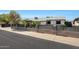 Charming single-story residence with a fountain in the front yard and decorative block fence at 8202 W Turney Ave, Phoenix, AZ 85033