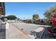 Well-maintained front yard with gray gravel and a brick-lined sidewalk and a fountain at 8202 W Turney Ave, Phoenix, AZ 85033