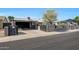 Inviting front yard with a driveway leading to a covered parking area and charming single story residence at 8202 W Turney Ave, Phoenix, AZ 85033