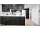 Beautiful kitchen showcasing stylish black cabinetry, white countertops, and modern appliances at 8202 W Turney Ave, Phoenix, AZ 85033
