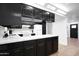 Well-lit kitchen boasting black cabinets, light countertops, and a functional layout for culinary enthusiasts at 8202 W Turney Ave, Phoenix, AZ 85033