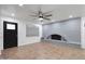 Cozy living room featuring a gray brick fireplace, tile flooring, and ceiling fan for added comfort at 8202 W Turney Ave, Phoenix, AZ 85033
