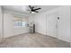 Cozy room with a window, door to exterior, mini refrigerator, and a ceiling fan at 8202 W Turney Ave, Phoenix, AZ 85033