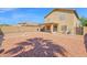 Open backyard featuring a fire pit, rock landscaping, a covered patio, and block fence at 885 E Lakeview Dr, San Tan Valley, AZ 85143