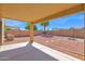 Covered patio overlooking low-maintenance backyard with rock landscaping, brick fence, and a palm tree at 885 E Lakeview Dr, San Tan Valley, AZ 85143