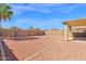 Large low-maintenance backyard featuring a fire pit, block fence, palm tree, and landscaping at 885 E Lakeview Dr, San Tan Valley, AZ 85143