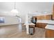 Open kitchen with wood cabinets and countertops flows seamlessly into the living room at 885 E Lakeview Dr, San Tan Valley, AZ 85143