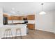 Modern kitchen with wood cabinets, sleek countertops, and a breakfast bar with seating at 885 E Lakeview Dr, San Tan Valley, AZ 85143