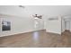Bright living room with wood-look tile floors, large windows, and neutral paint scheme at 885 E Lakeview Dr, San Tan Valley, AZ 85143