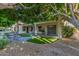 Lovely backyard featuring artificial turf, a paved patio, and shaded seating for outdoor enjoyment at 9326 E Princess Dr, Mesa, AZ 85207