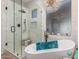 Elegant bathroom with a freestanding tub, walk-in shower, and stylish chandelier at 9326 E Princess Dr, Mesa, AZ 85207