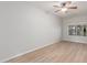 Empty bedroom with wood-look floors, a ceiling fan, and a window at 9326 E Princess Dr, Mesa, AZ 85207