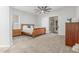 Cozy bedroom featuring a wood bed frame, neutral carpet, and sliding glass doors at 9326 E Princess Dr, Mesa, AZ 85207