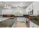 Bright kitchen with white cabinets, stainless steel appliances, and granite countertops at 9326 E Princess Dr, Mesa, AZ 85207