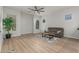 Cozy living room with wood floors, plush sofa, and large windows for natural light at 9326 E Princess Dr, Mesa, AZ 85207