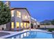 Inviting backyard with a sparkling pool, covered patio, and desert landscaping against a mountain backdrop at 9571 E Nittany Dr, Scottsdale, AZ 85255