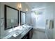 Bright bathroom features dual sinks, modern lighting, and a tub/shower combo at 9571 E Nittany Dr, Scottsdale, AZ 85255