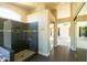 Tiled walk-in shower in bathroom leads to bedroom and closet with mirrored doors at 9571 E Nittany Dr, Scottsdale, AZ 85255