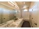 Bright bathroom with dual sinks, a large mirror, and a separate tub at 9571 E Nittany Dr, Scottsdale, AZ 85255