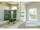 Bathroom features double vanity, a soaking tub with mountain views, and tiled walk-in shower at 9571 E Nittany Dr, Scottsdale, AZ 85255