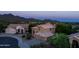 Elegant two-story home boasts desert landscaping and a three-car garage, set against a mountain backdrop at 9571 E Nittany Dr, Scottsdale, AZ 85255