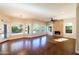 Beautiful living room with wood floors, many windows, fireplace, and modern light fixture at 9571 E Nittany Dr, Scottsdale, AZ 85255